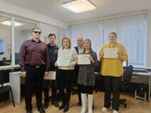 Тифлокомментарий к фотографии: Компьютерный класс Института «Реакомп». Заместитель генерального директора по информационным технологиям Е.Е. Арнапольский вместе с выпускниками программы «Информационные технологии» и преподавателем В.В. Гладышевым